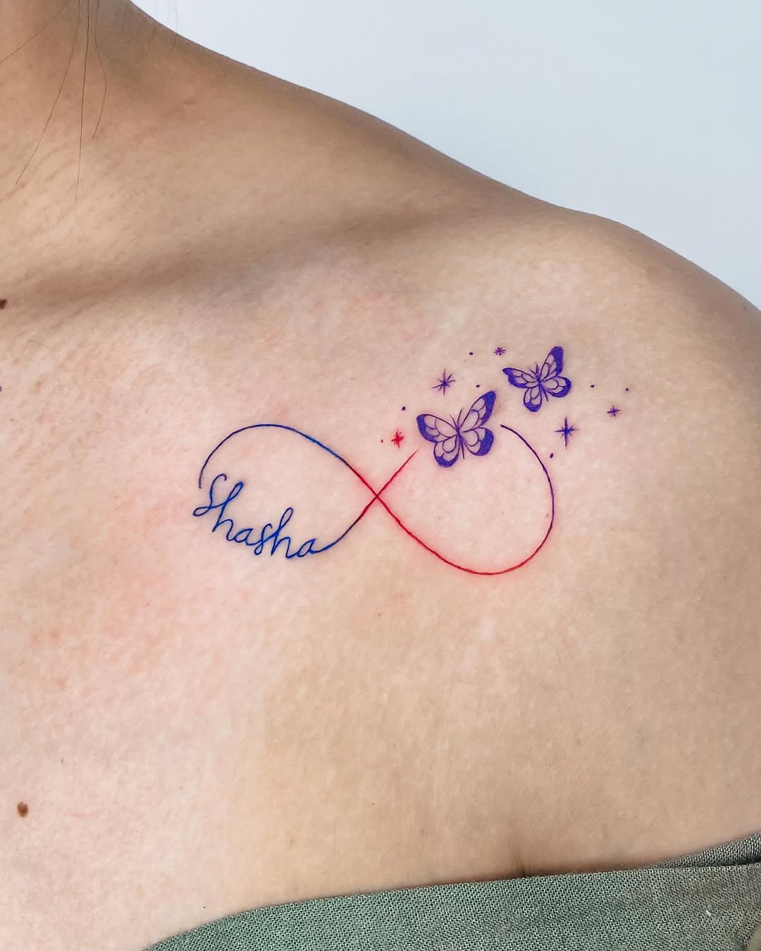 Unique infinity tattoo featuring delicate butterflies