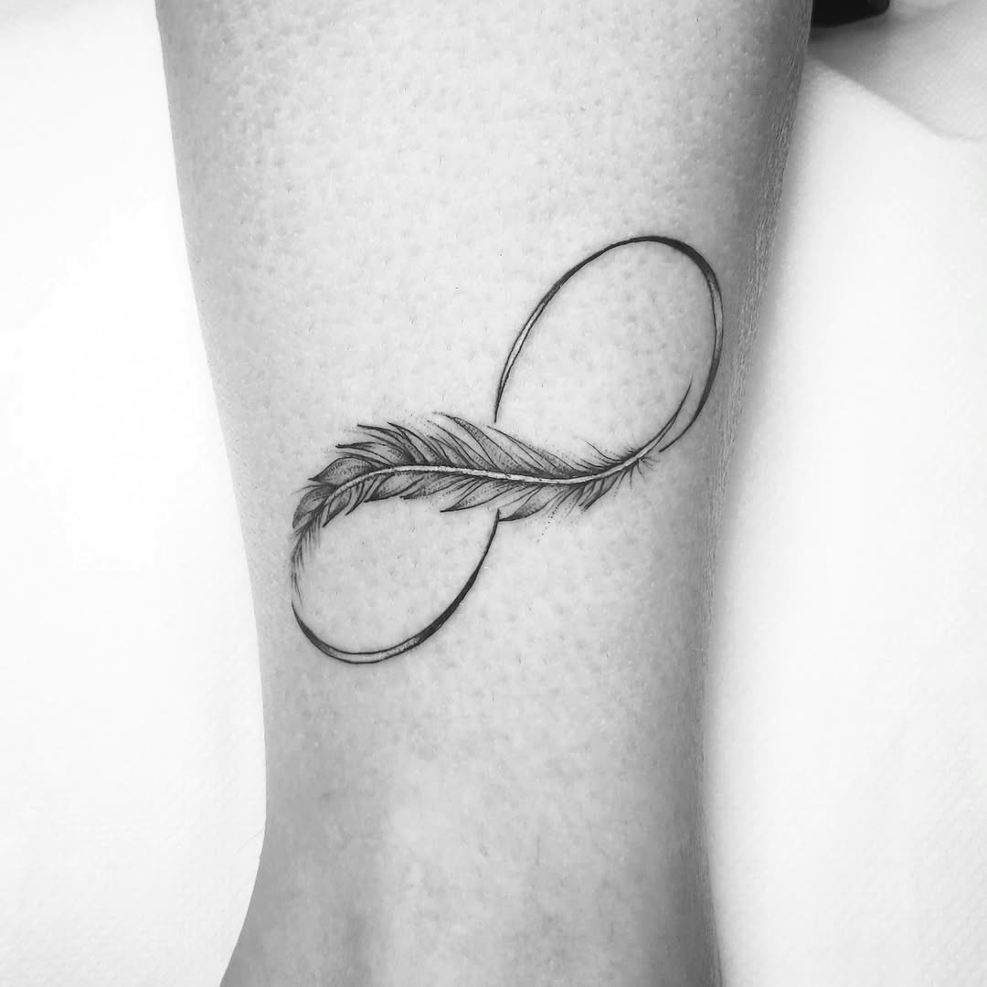 Elegant infinity tattoo with a feather design