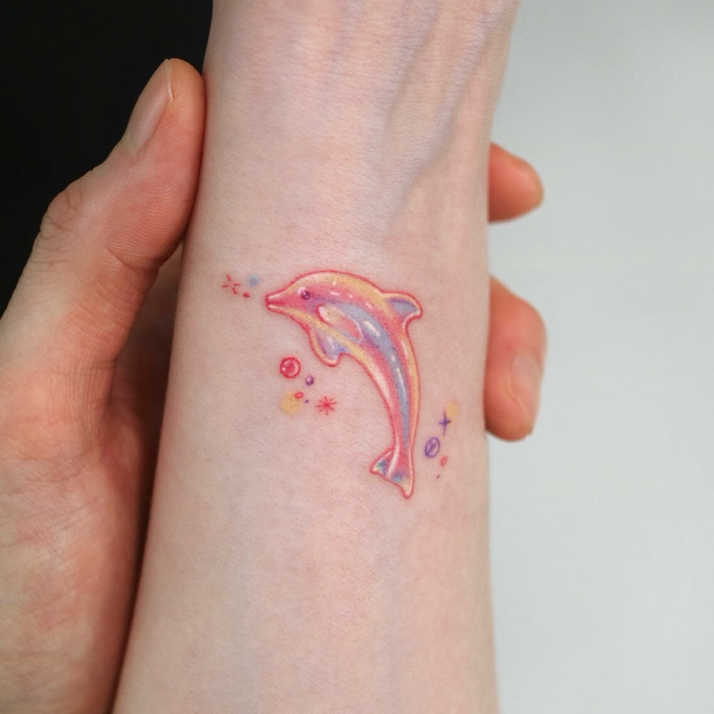 Playful dolphin tattoo with colorful splashes