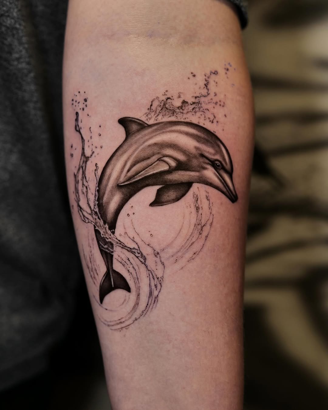 Elegant dolphin tattoo with playful water splash