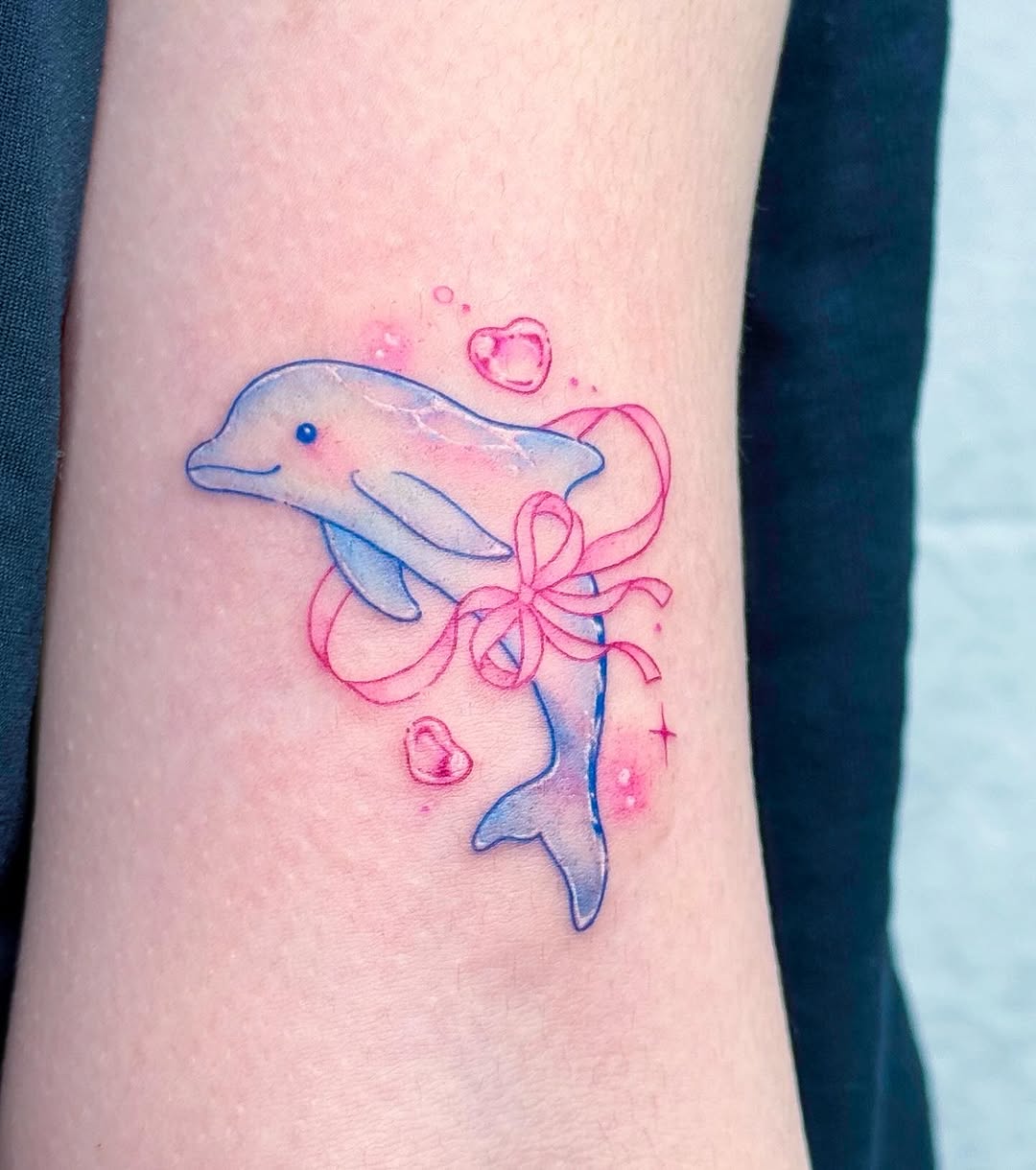 Charming dolphin tattoo with playful ribbons