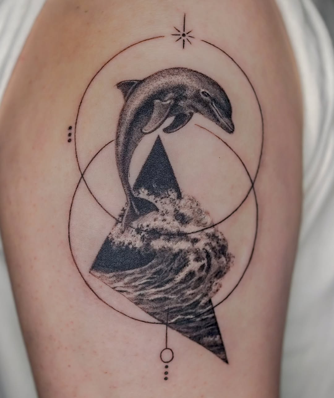 Stunning dolphin tattoo with geometric elements
