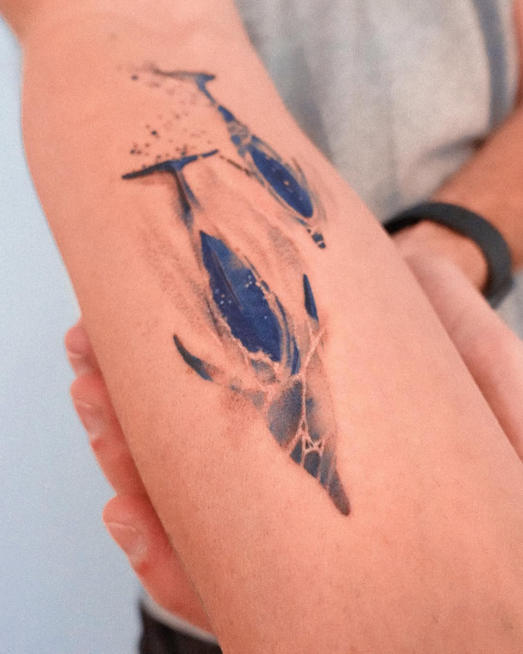 Stunning blue watercolor dolphin tattoo design