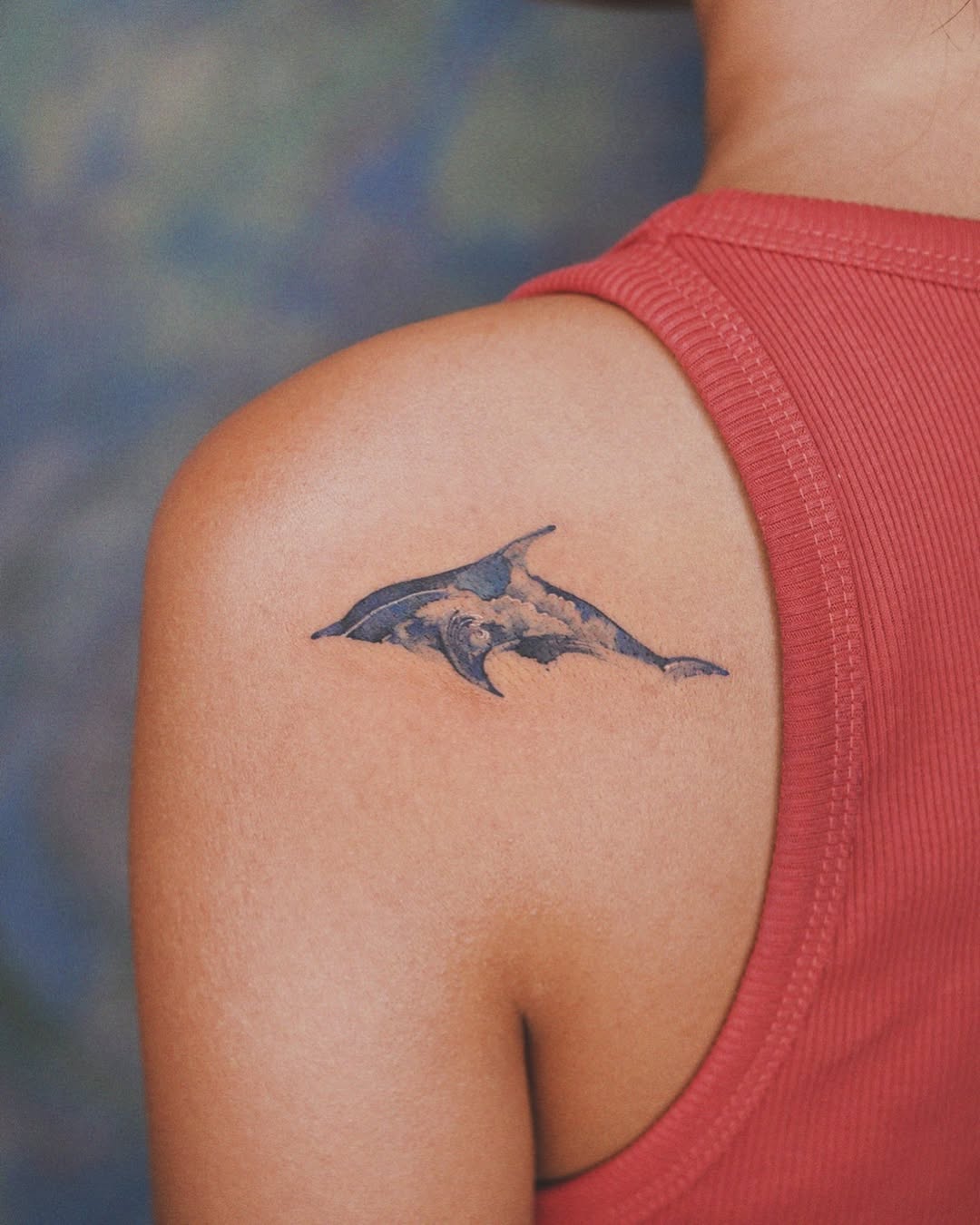 Colorful dolphin tattoo on shoulder