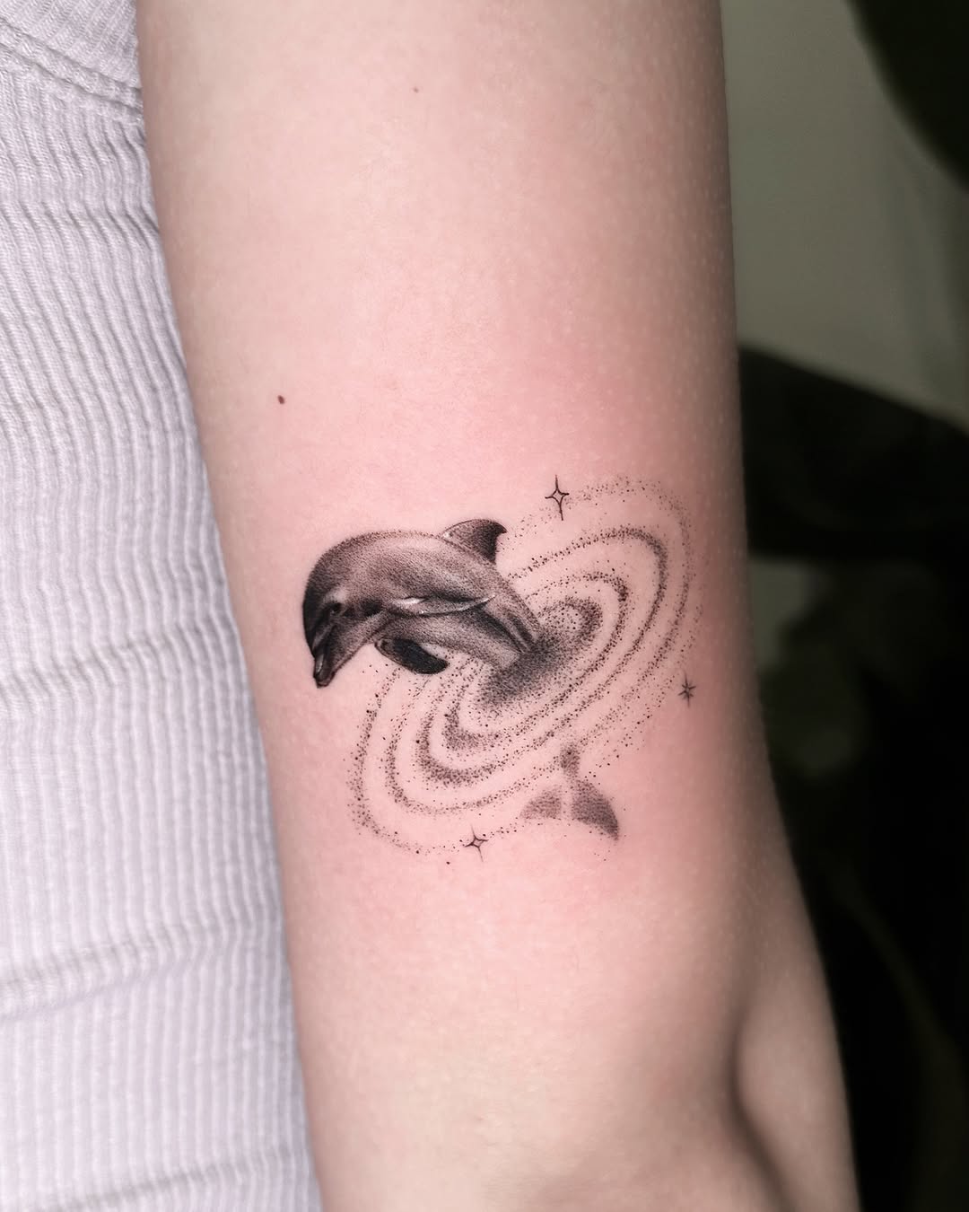Stunning dolphin tattoo with galaxy vibes