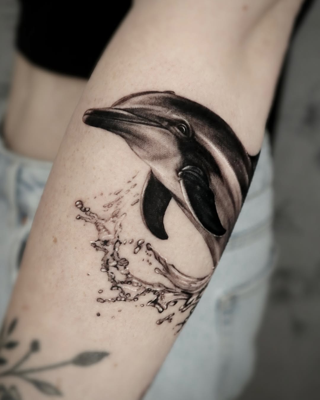 Elegant realistic dolphin tattoo with water splash