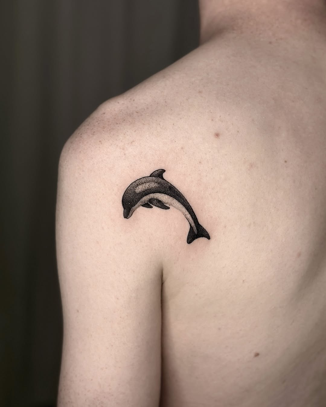Minimalist Dolphin Tattoo on Shoulder