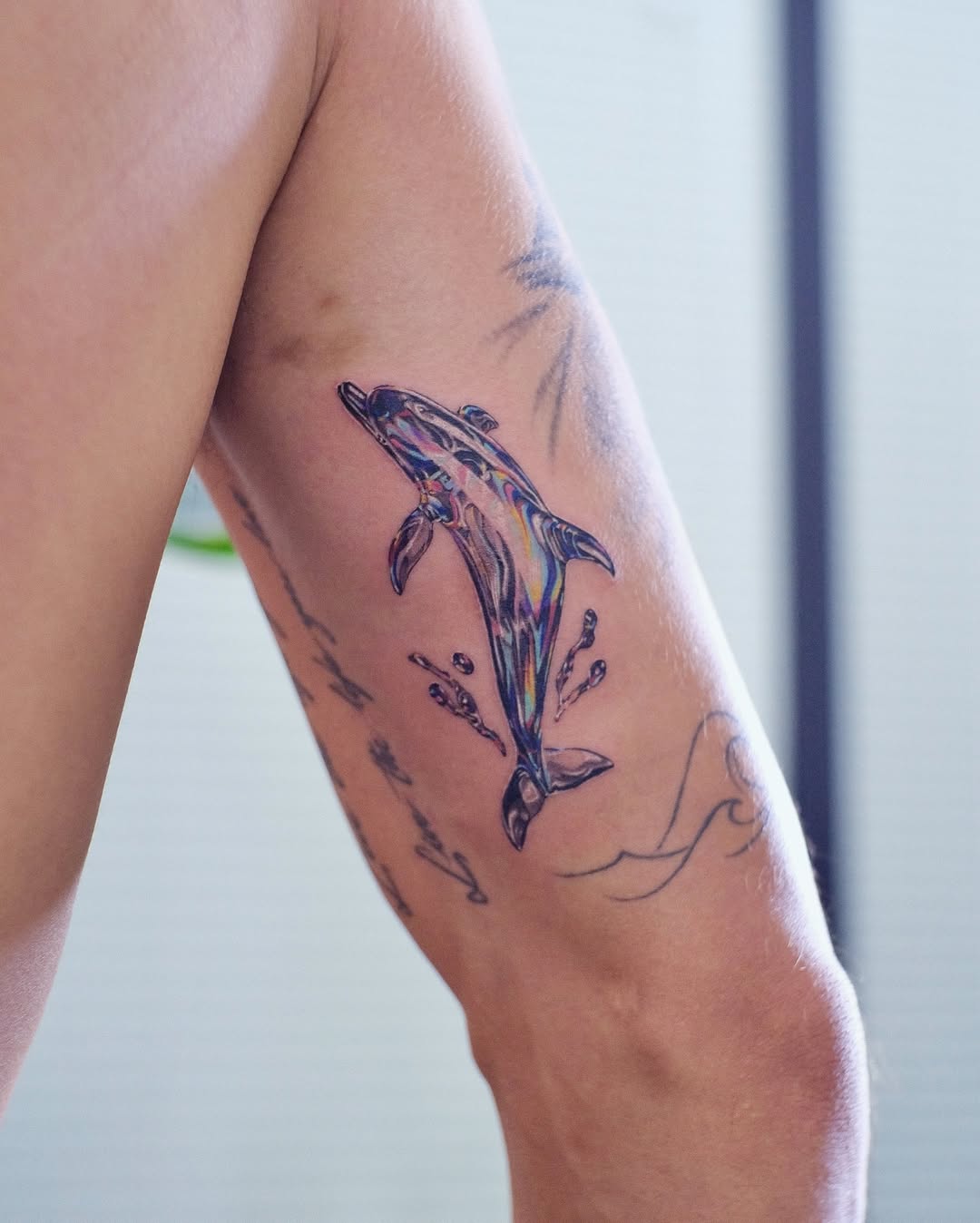 Vibrant dolphin tattoo design on the arm