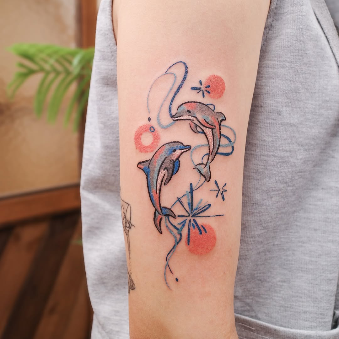 Captivating dolphins in playful motion tattoo