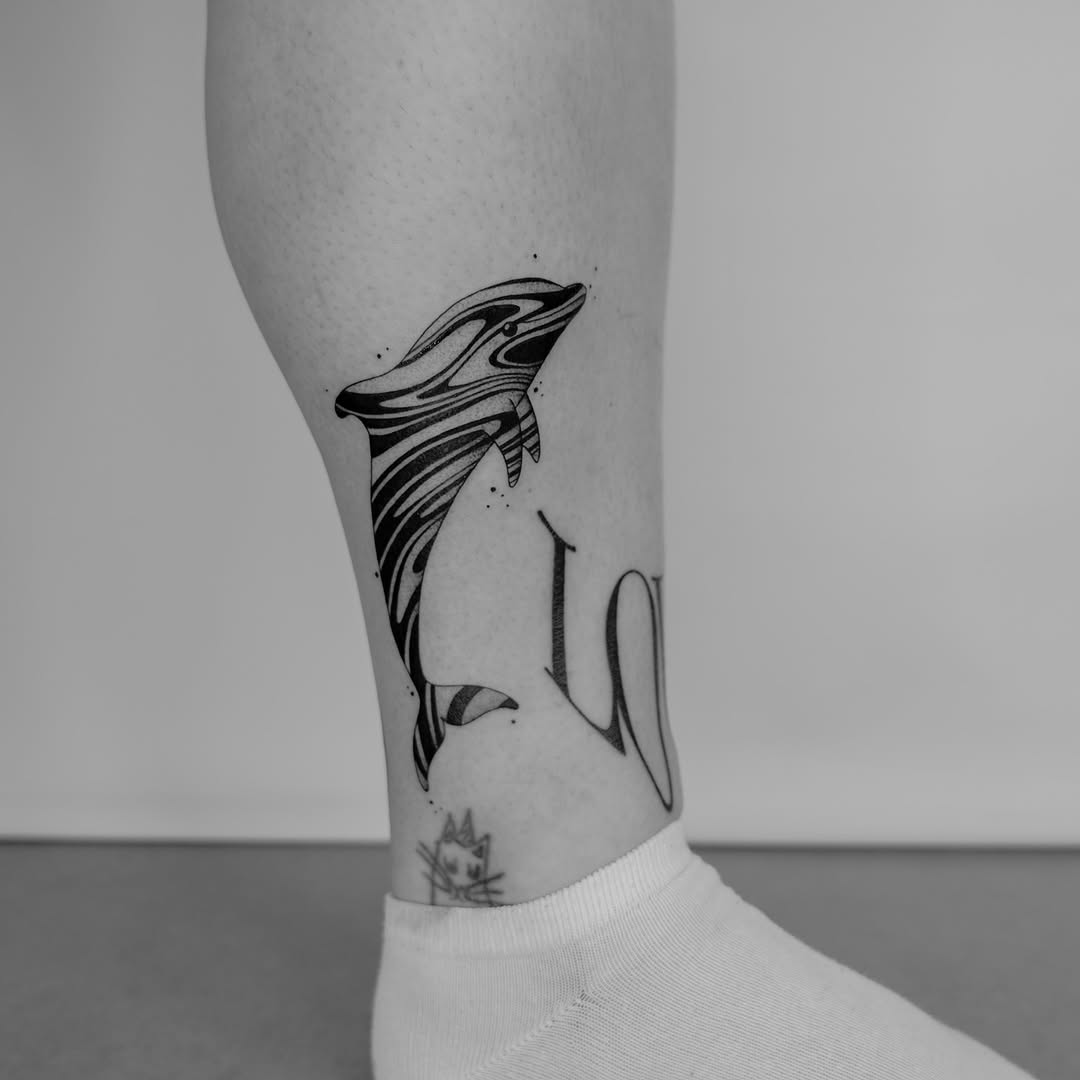 Stylized dolphin tattoo with elegant lettering