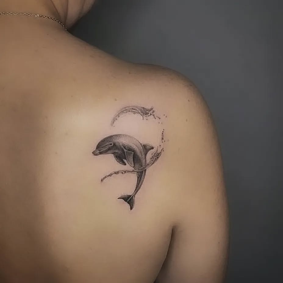 Elegant dolphin tattoo with graceful waves