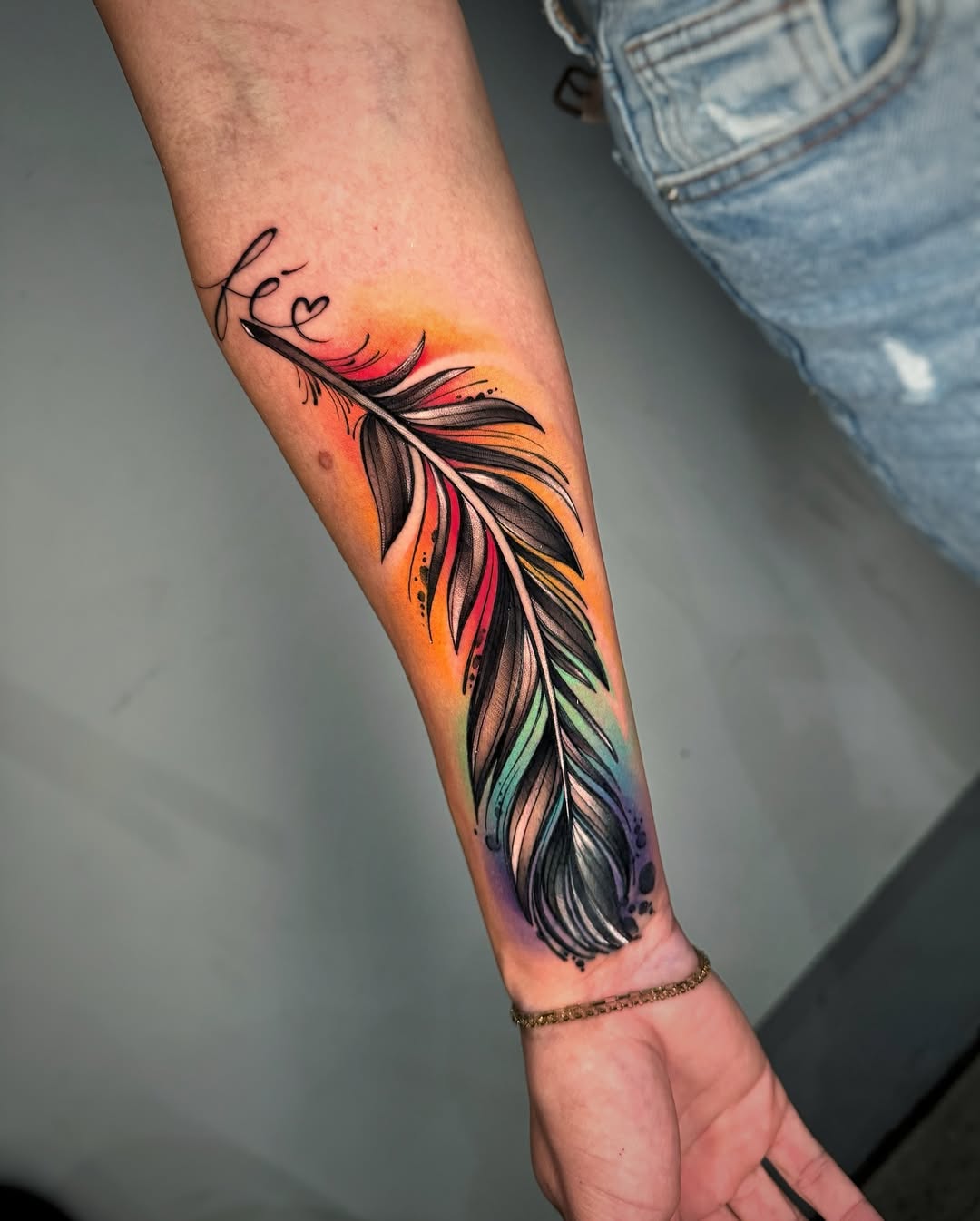 Vibrant feather tattoo with a colorful touch