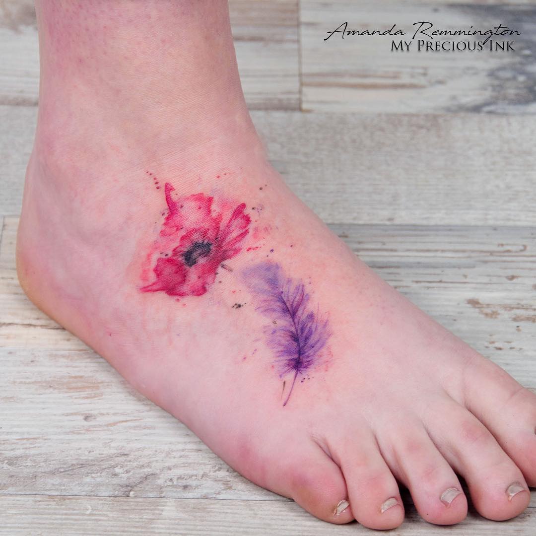 Vibrant flower and feather tattoos on the ankle