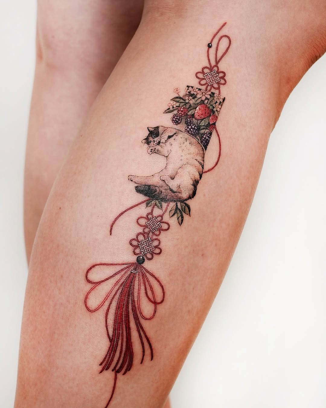Elegant Oriental Cat Tattoo with Floral Accents