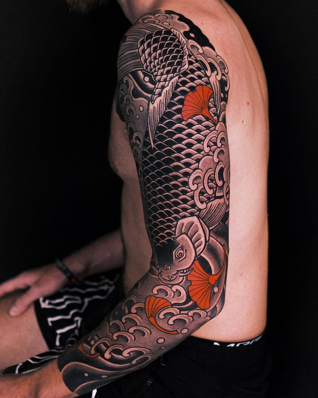 Elegant koi fish tattoo with wave motifs