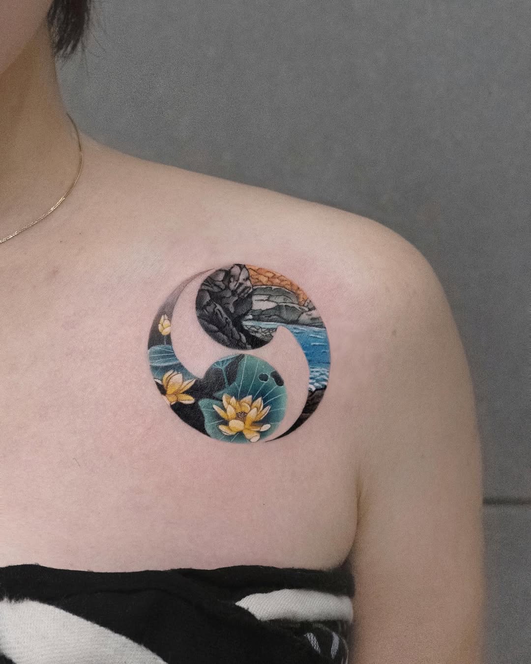 Intricate tattoo featuring lotus and waves