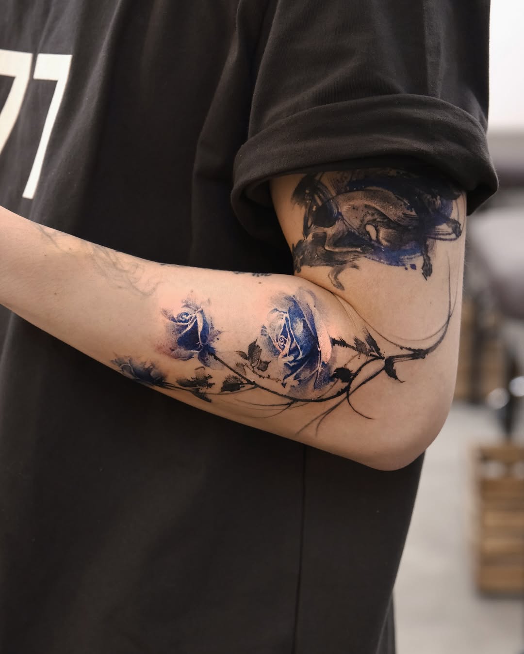 Elegant blue rose tattoo with artistic flair