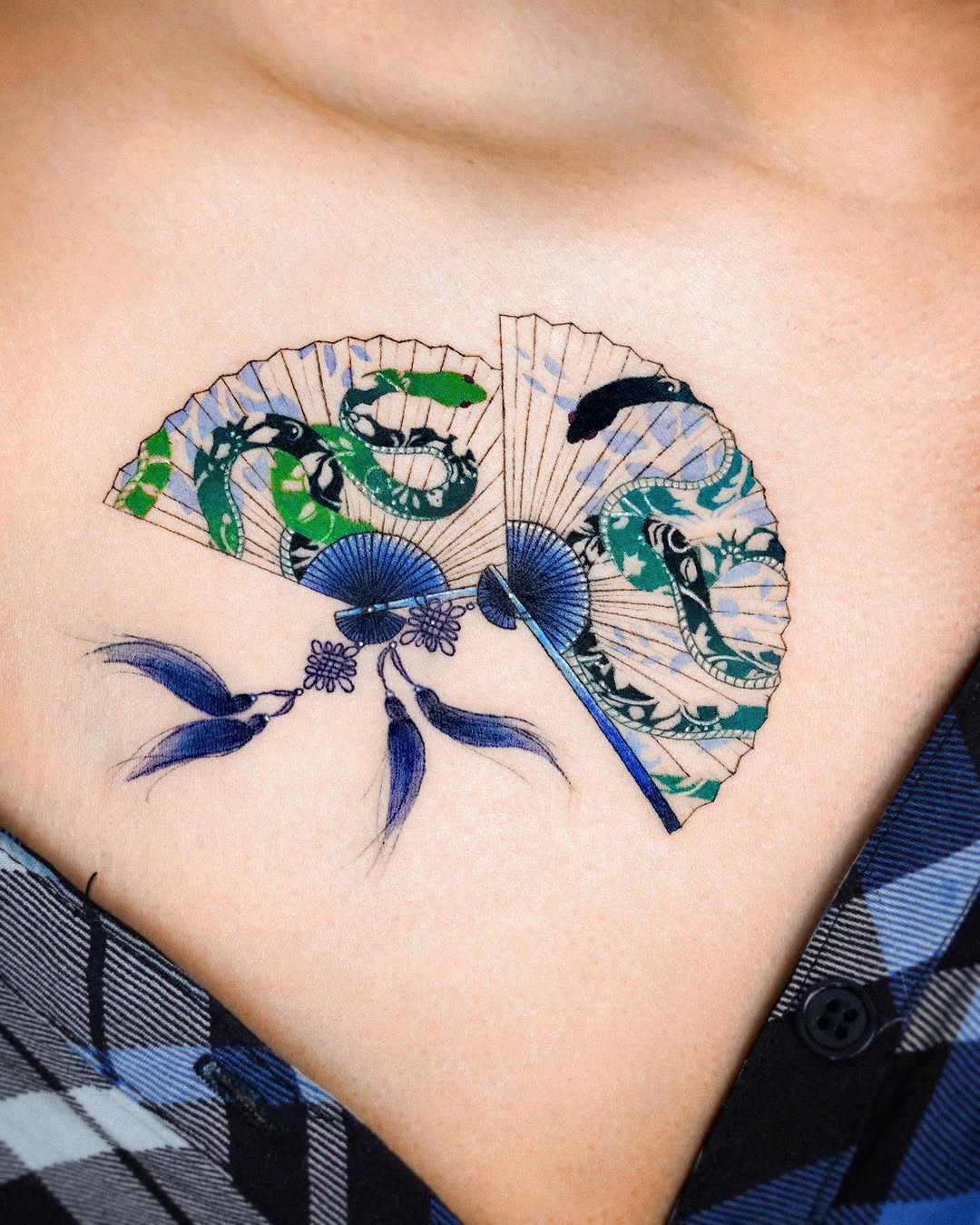 Intricate fan tattoo with serpent motifs