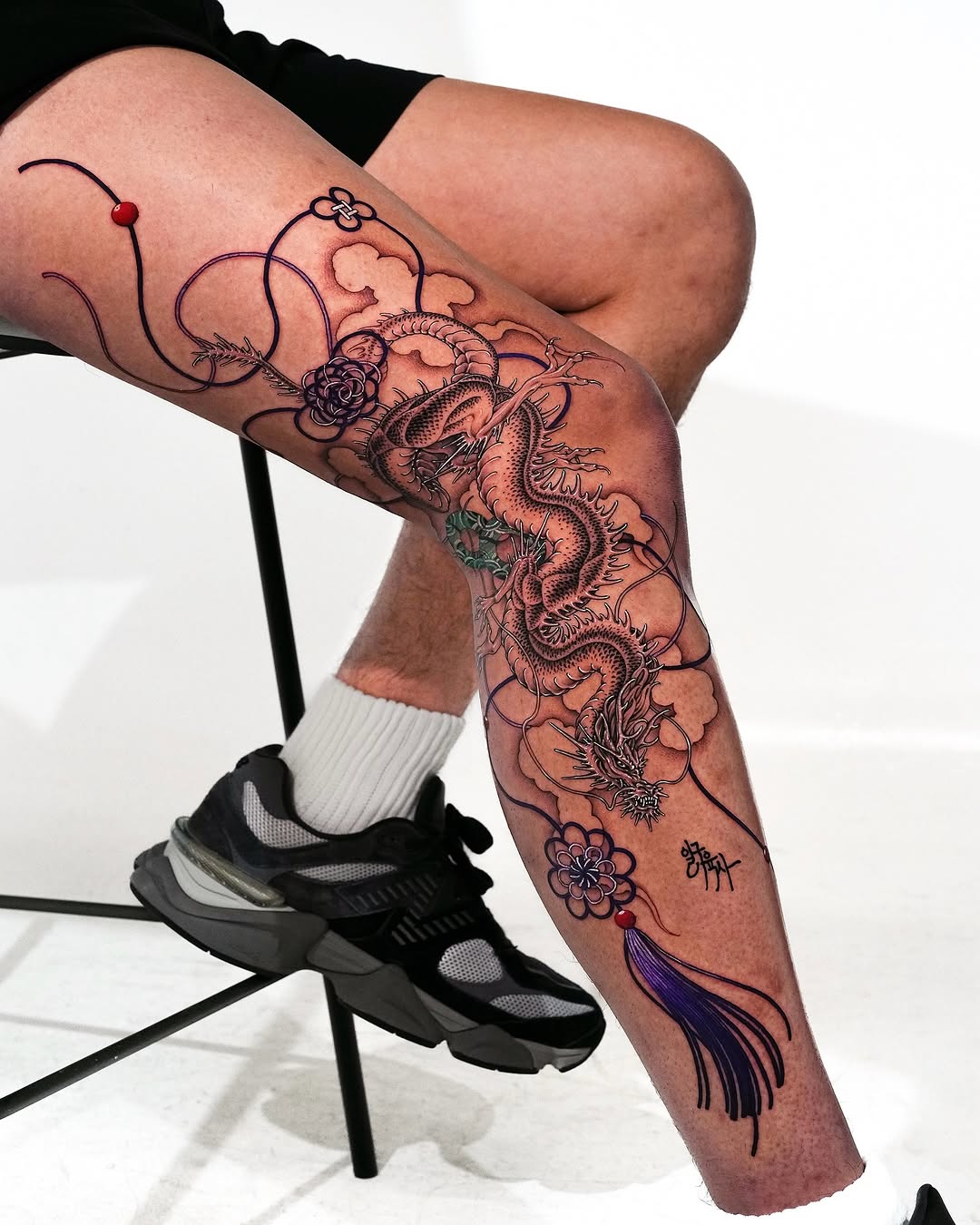 Intricate dragon tattoo adorned with floral motifs