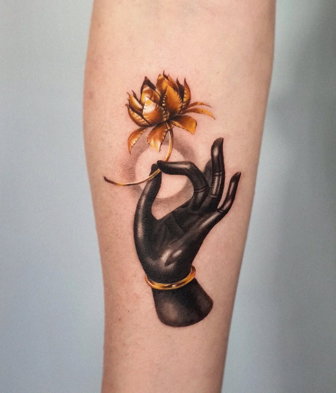 Elegant black hand with lotus flower tattoo