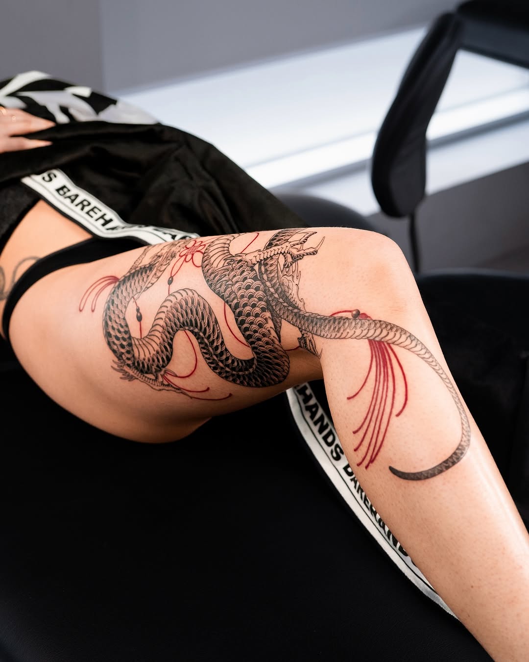 Stunning dragon tattoo wrapping the leg elegantly