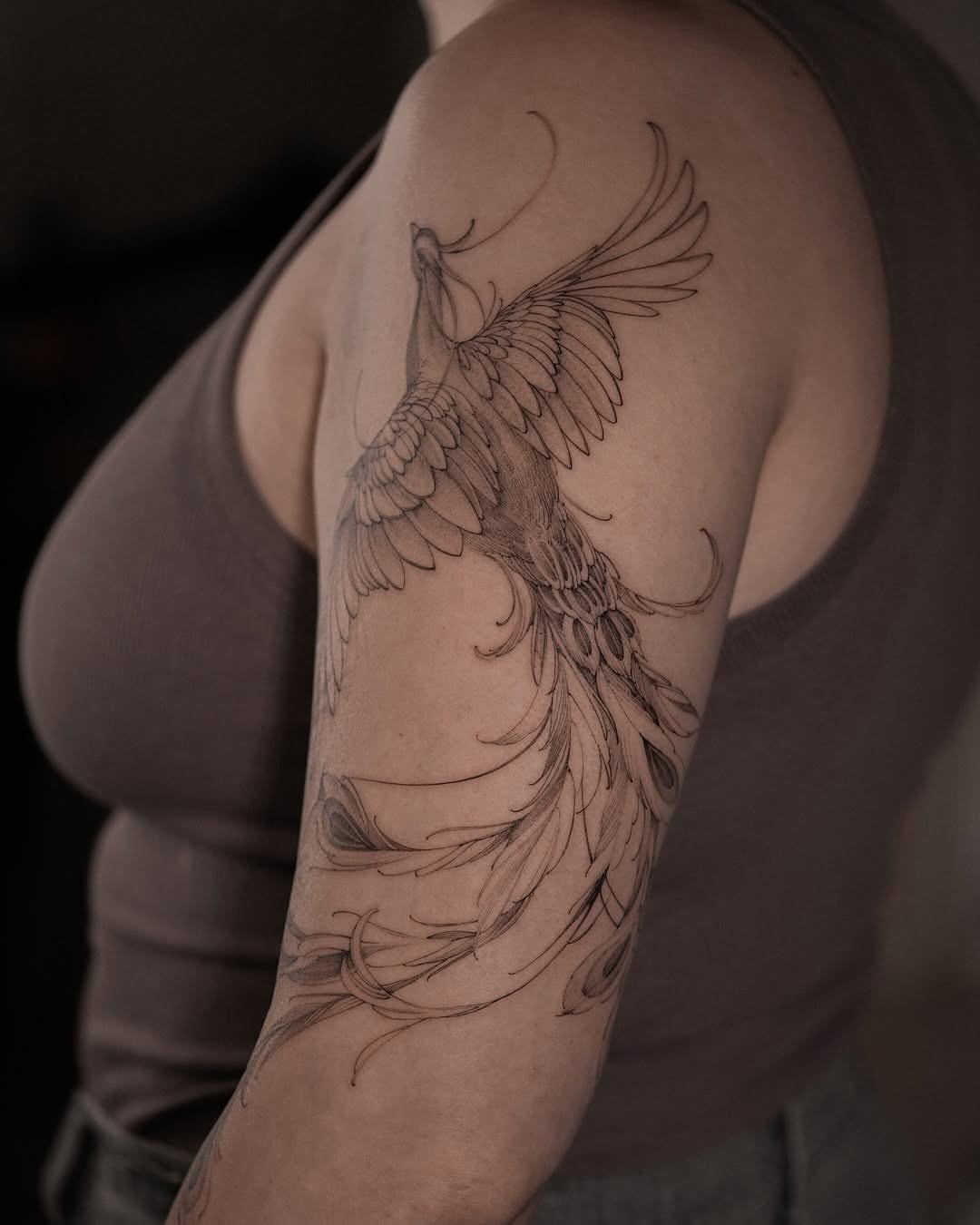 Elegant fine line peacock tattoo design