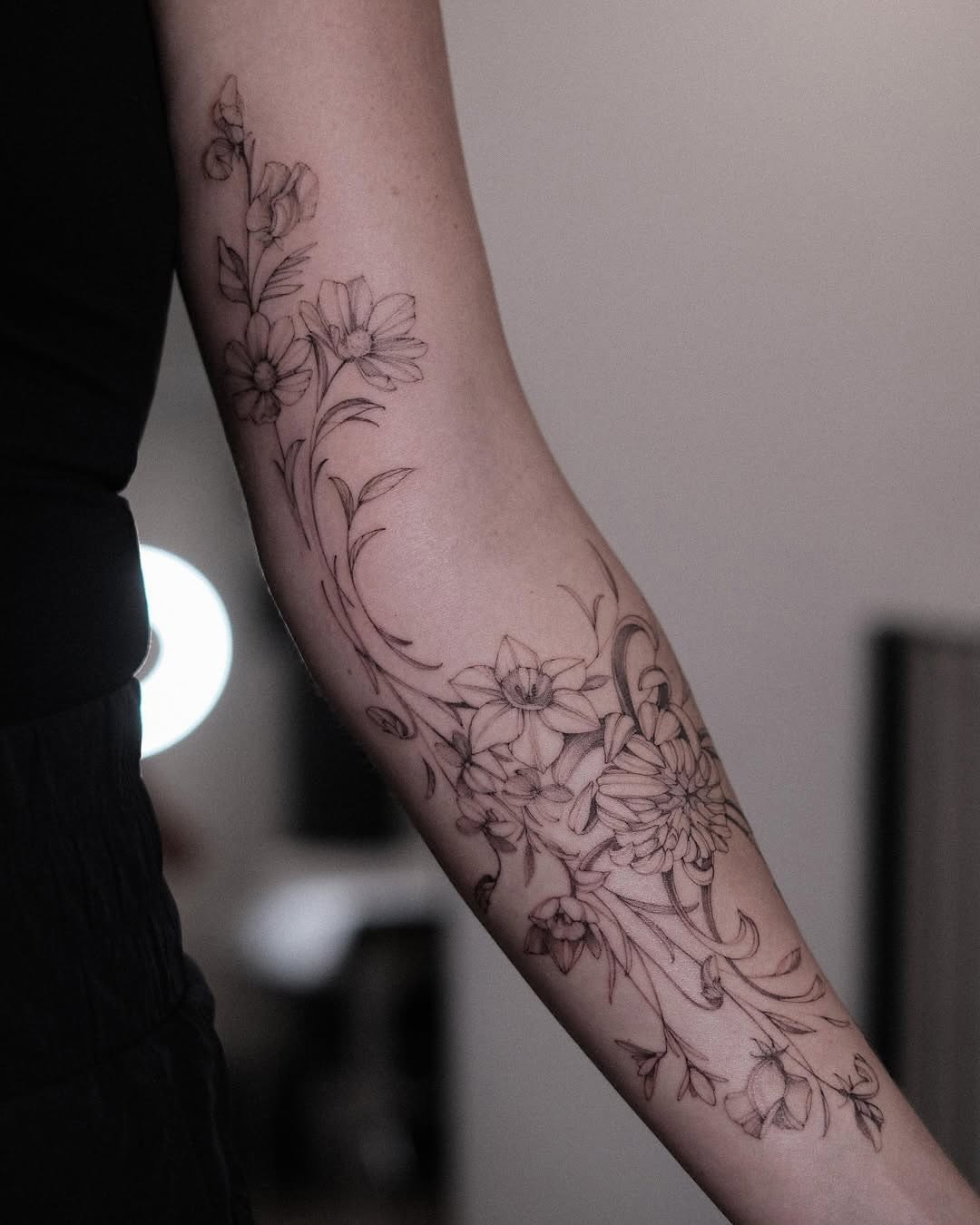 Delicate floral fine line tattoo design