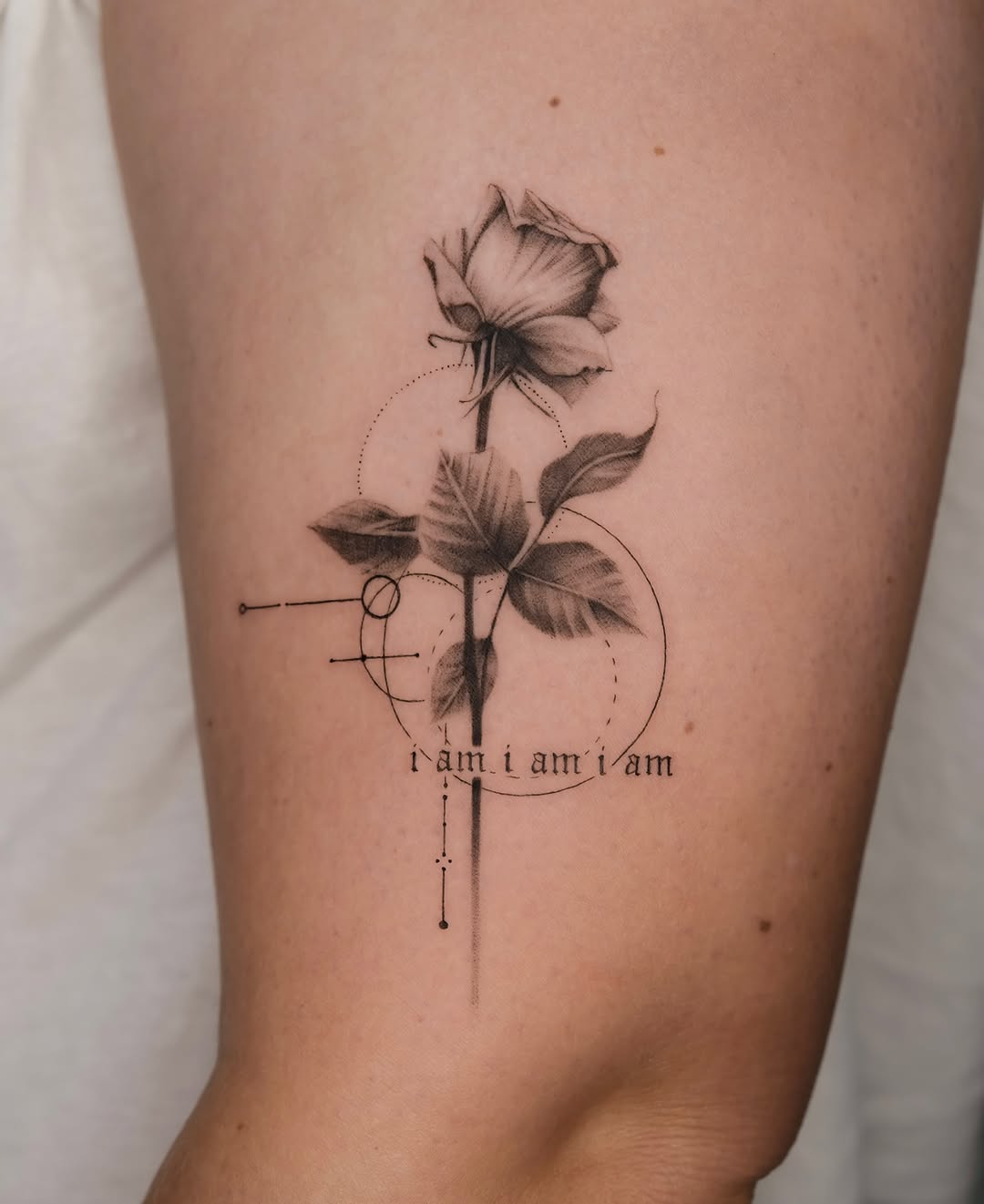 Elegant fine line rose tattoo with text