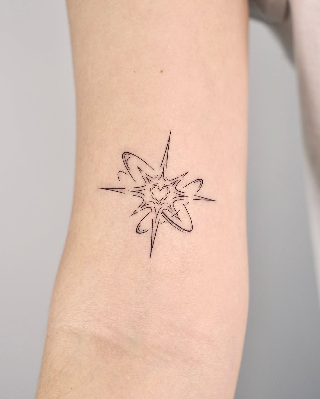 Chic Fine Line Starburst Tattoo Design