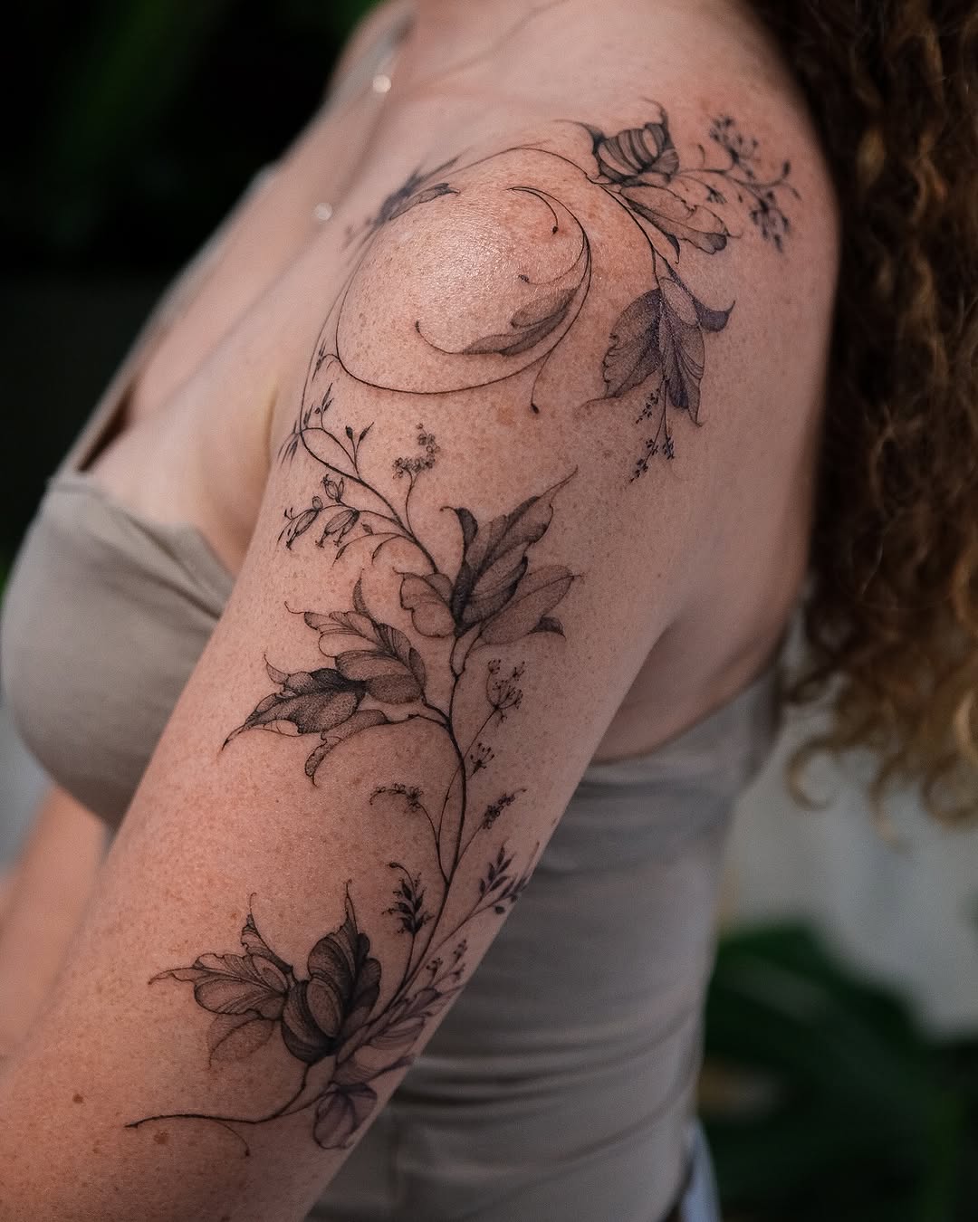 Elegant floral fine line tattoo on shoulder