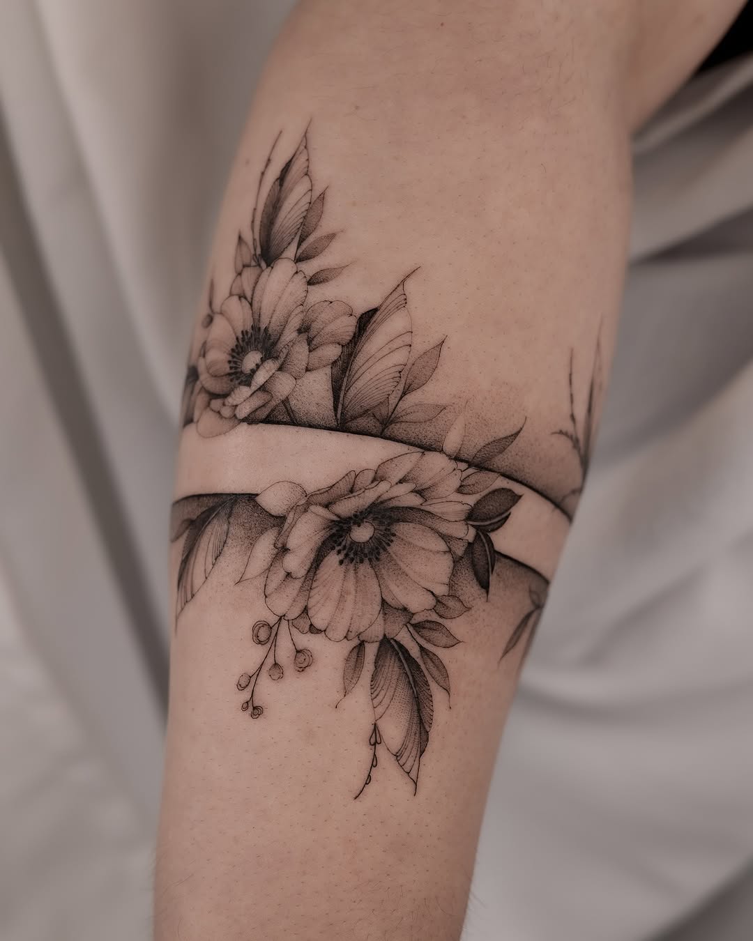 Delicate floral fine line tattoo design