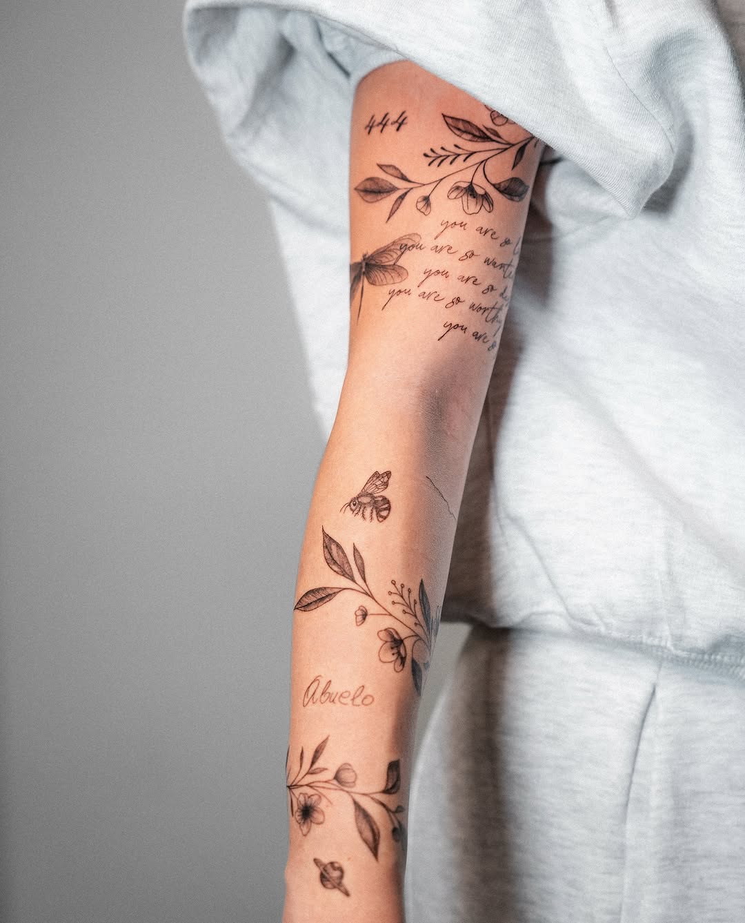 Elegant fine line floral and script tattoos
