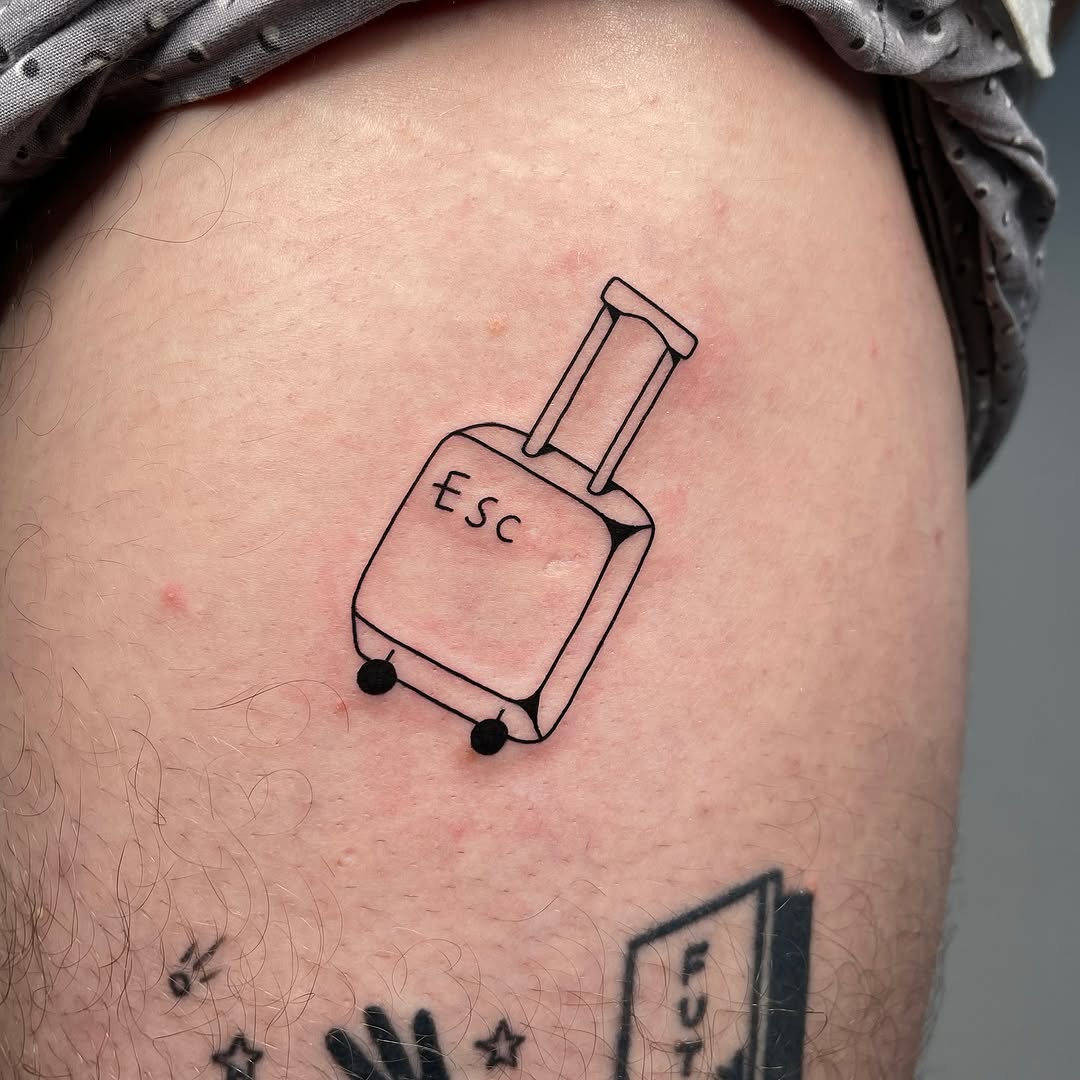 Whimsical suitcase tattoo for adventure lovers