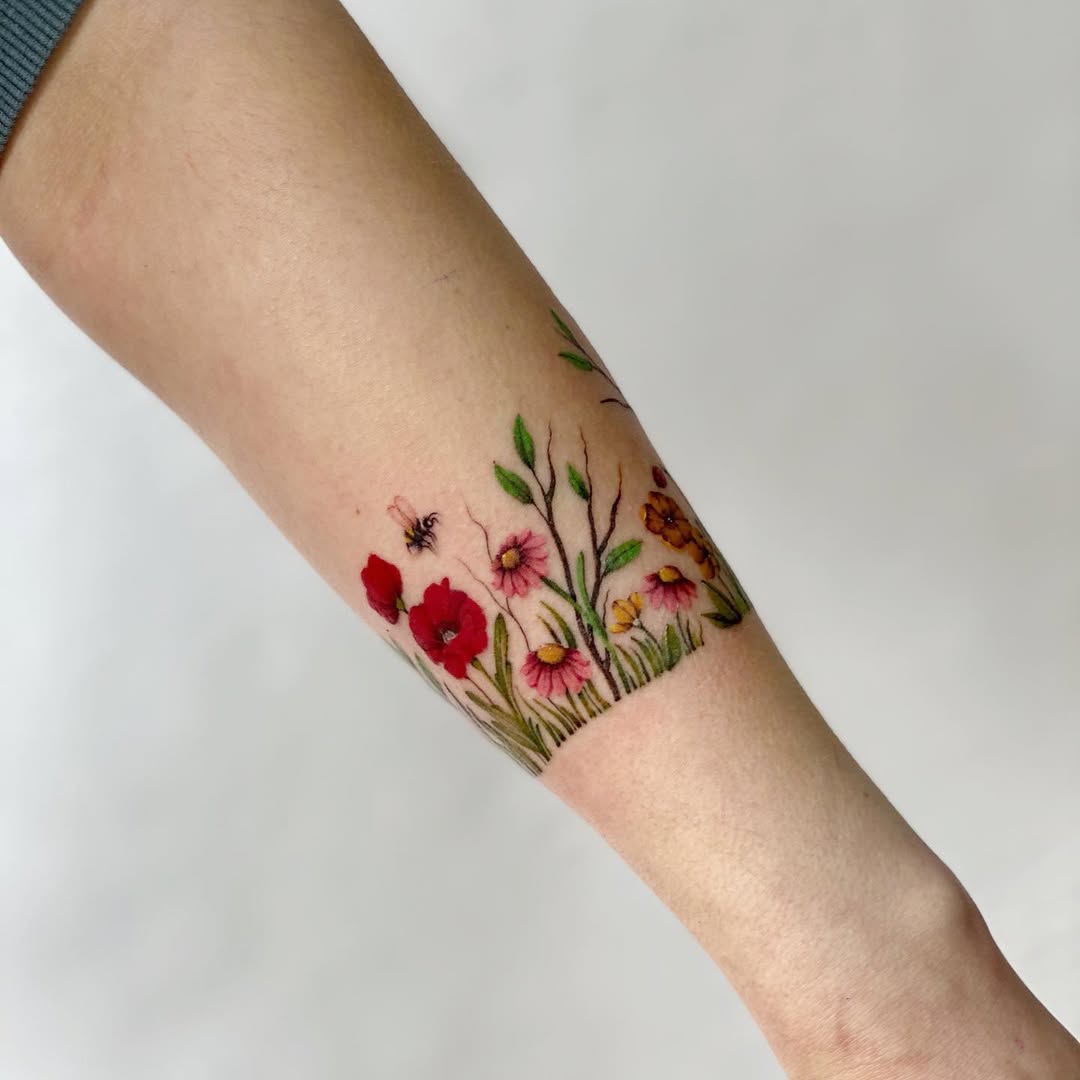 Vibrant floral bracelet tattoo with tiny insects