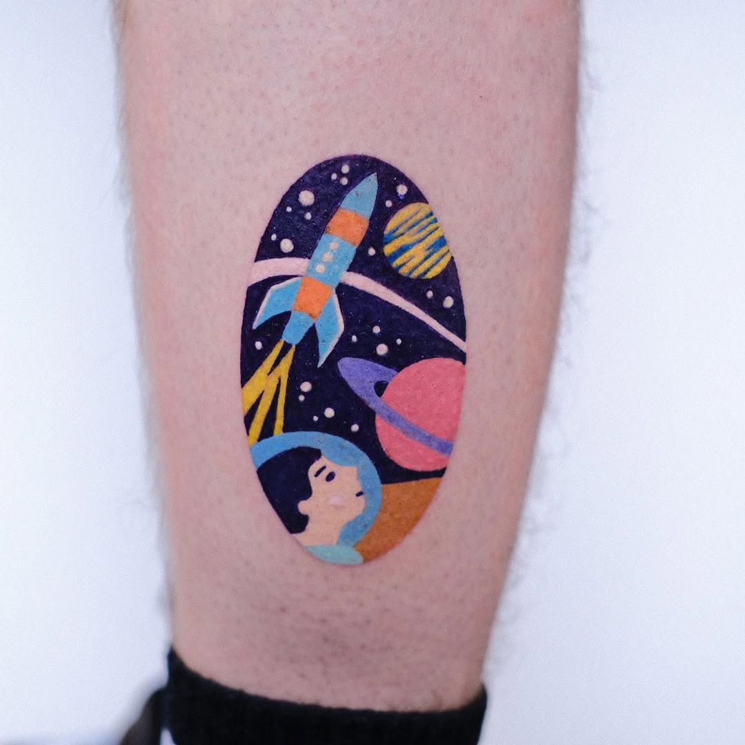 Vibrant space-themed tattoo with astronaut and rocket