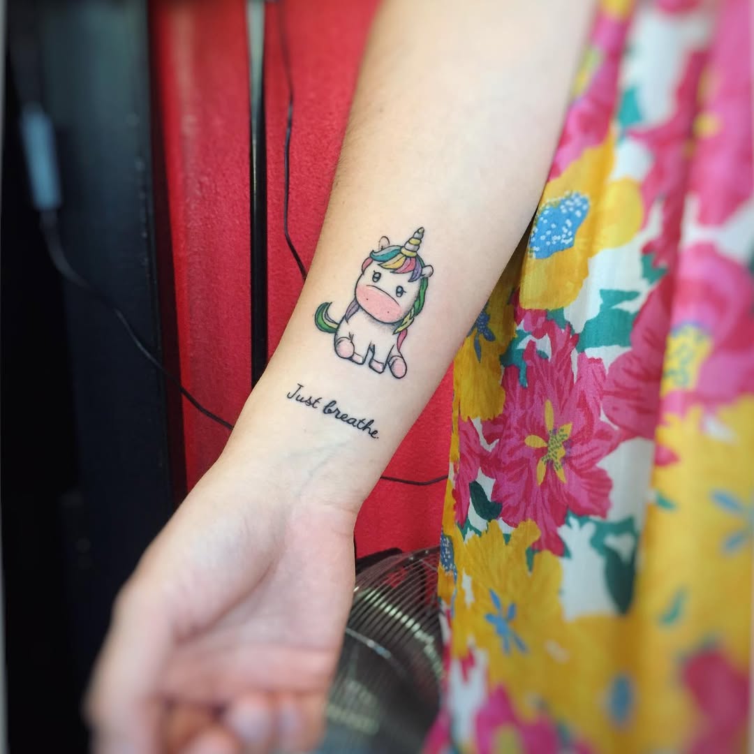 Charming unicorn tattoo with vibrant floral elements