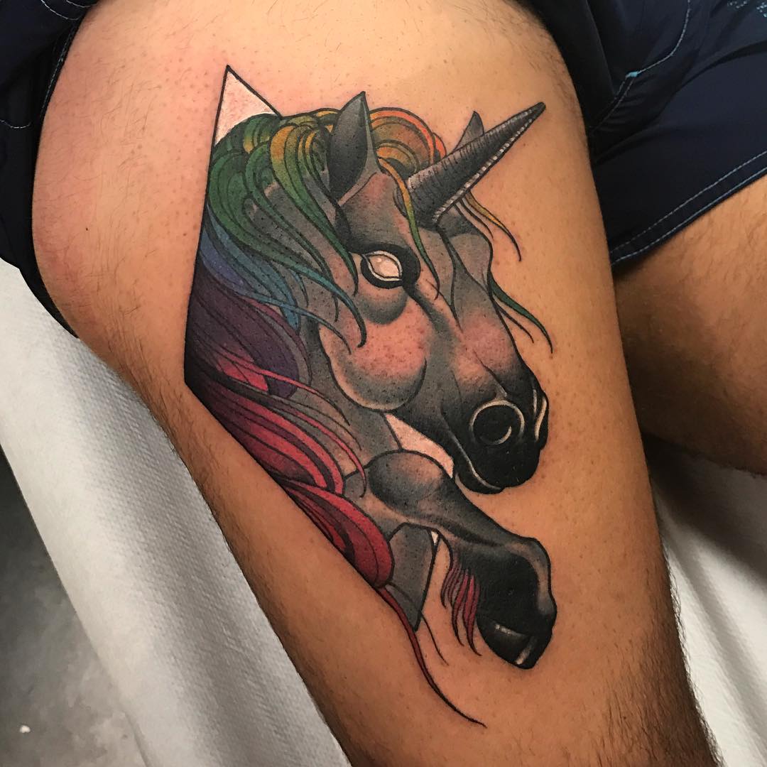 Vibrant unicorn tattoo with rainbow accents