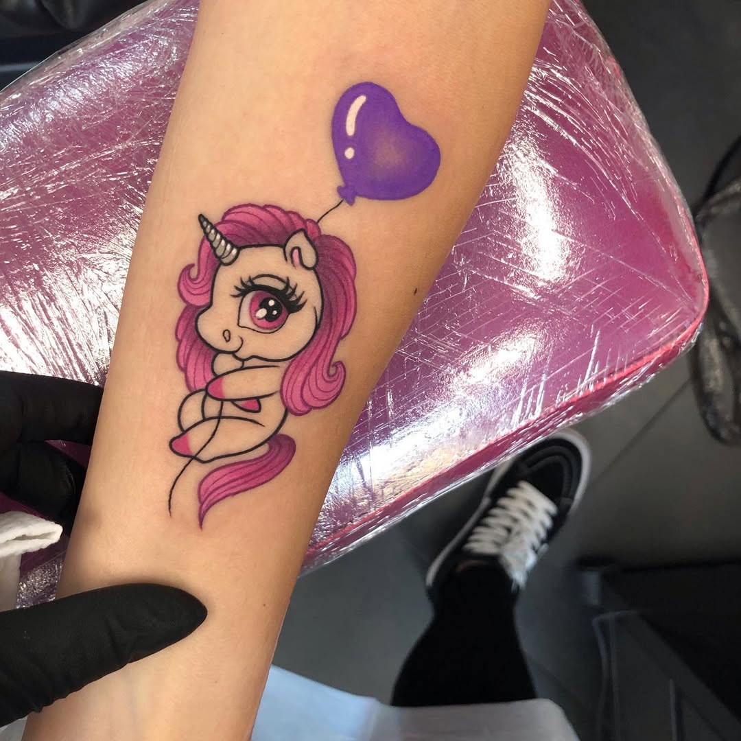 Adorable unicorn with a heart balloon tattoo