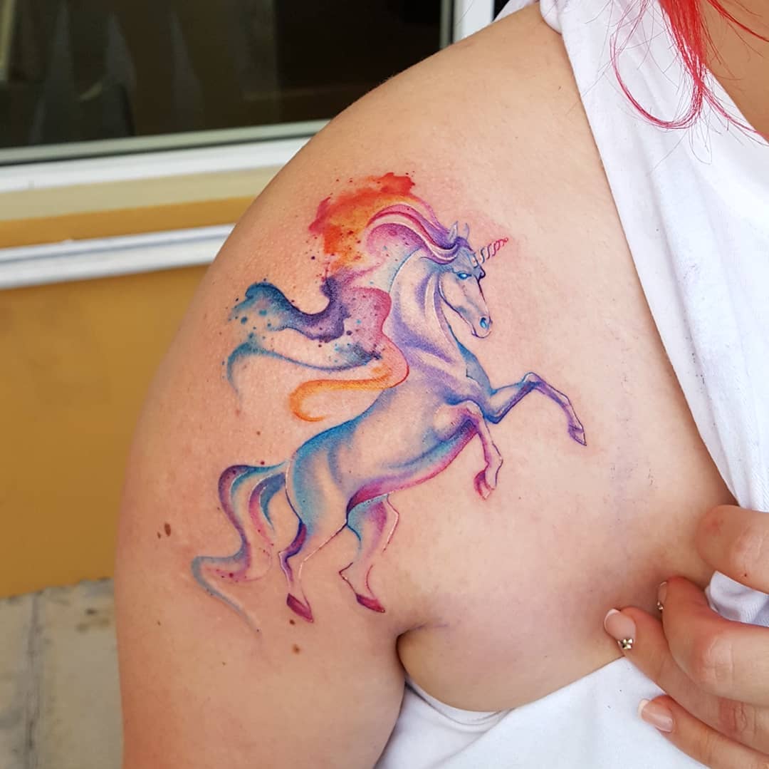 Whimsical watercolor unicorn tattoo design