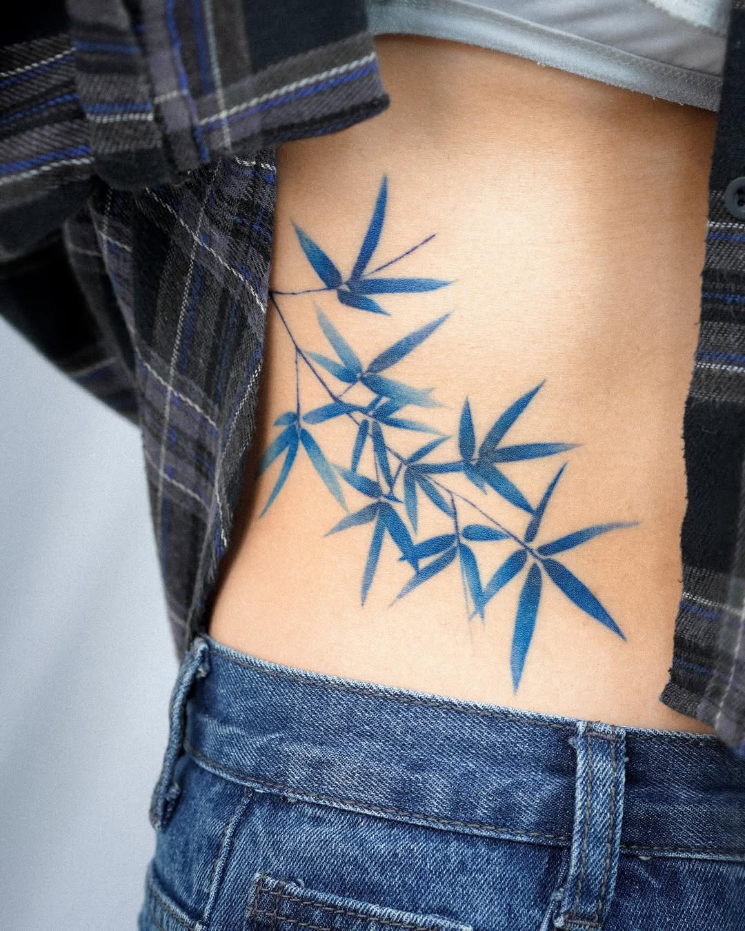 Elegant bamboo tattoo on the waist