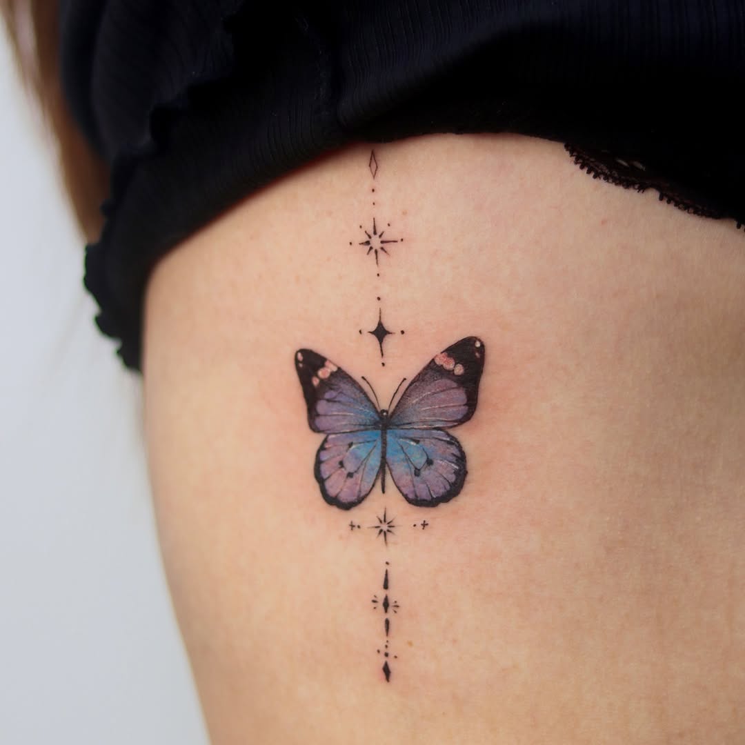 Vibrant butterfly tattoo with celestial elements