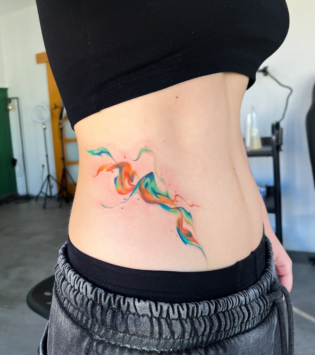 Vibrant abstract waist tattoo for creative expression