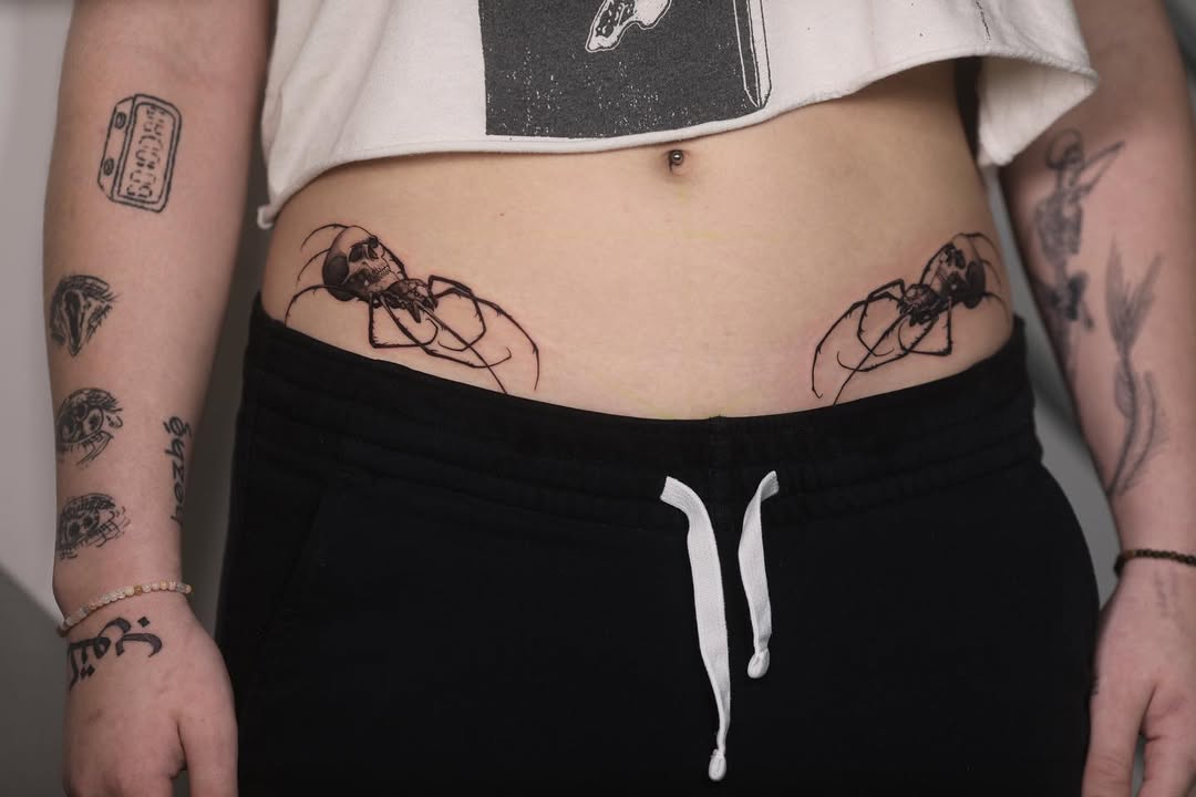 Striking waist tattoos featuring spider silhouettes