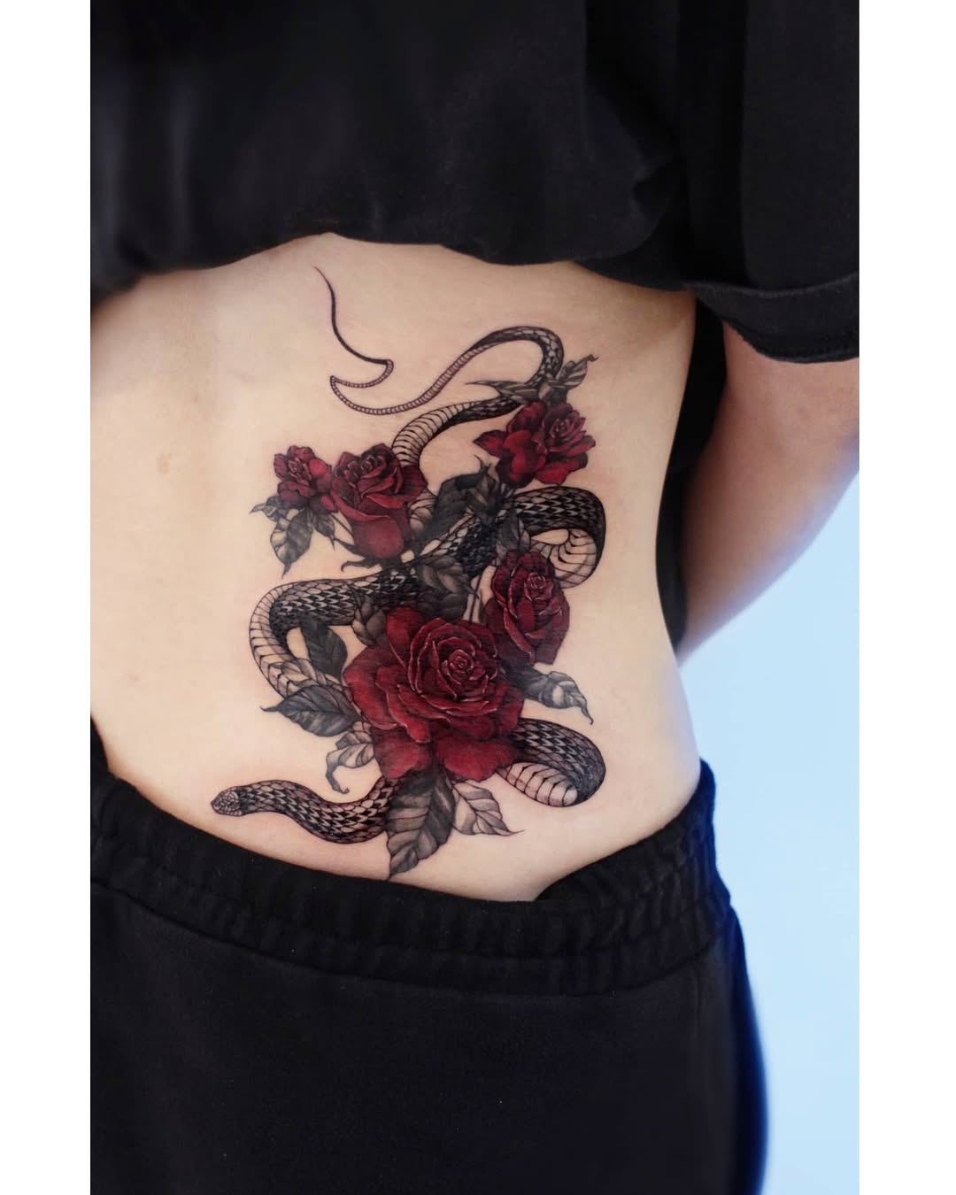 Stunning snake and rose waist tattoo art