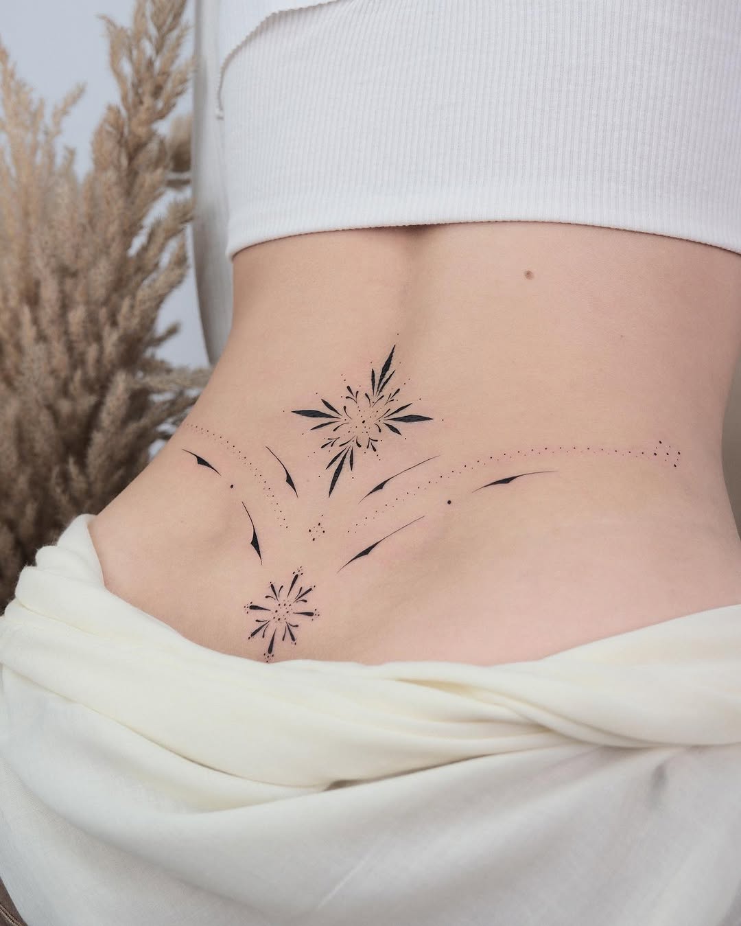 Elegant floral waist tattoo design for women