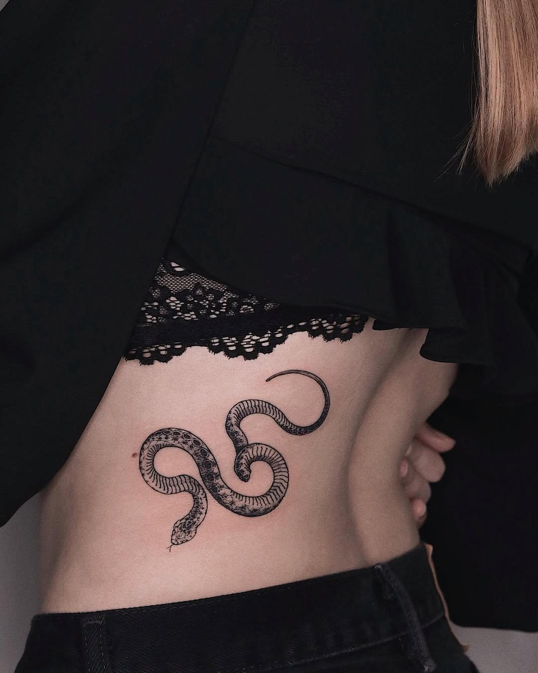 Elegant snake tattoo gracing the waist area