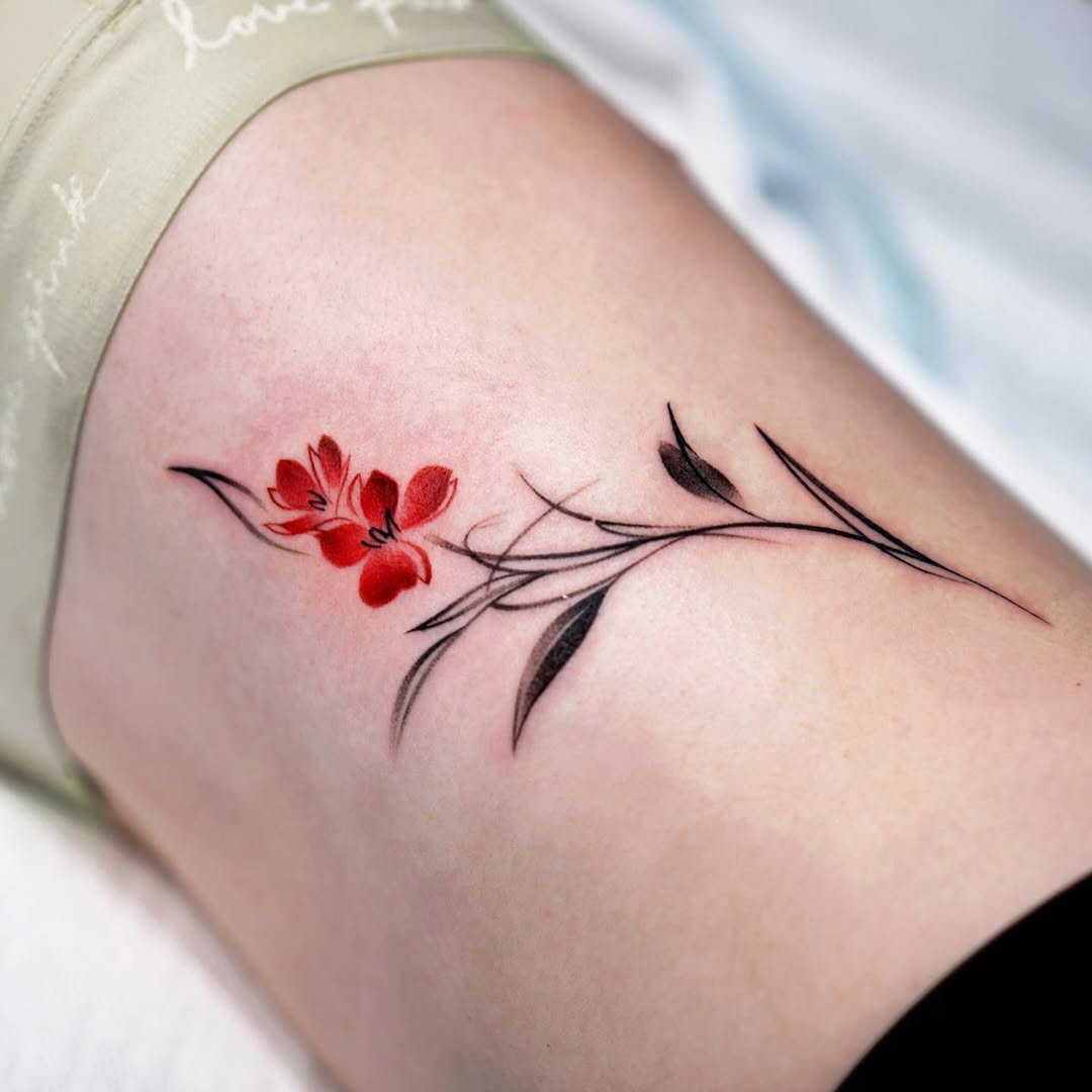 Elegant waist tattoo featuring delicate red florals