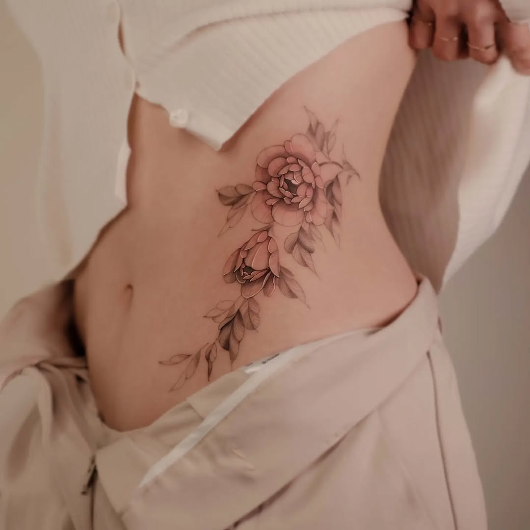 Elegant floral waist tattoo design for women