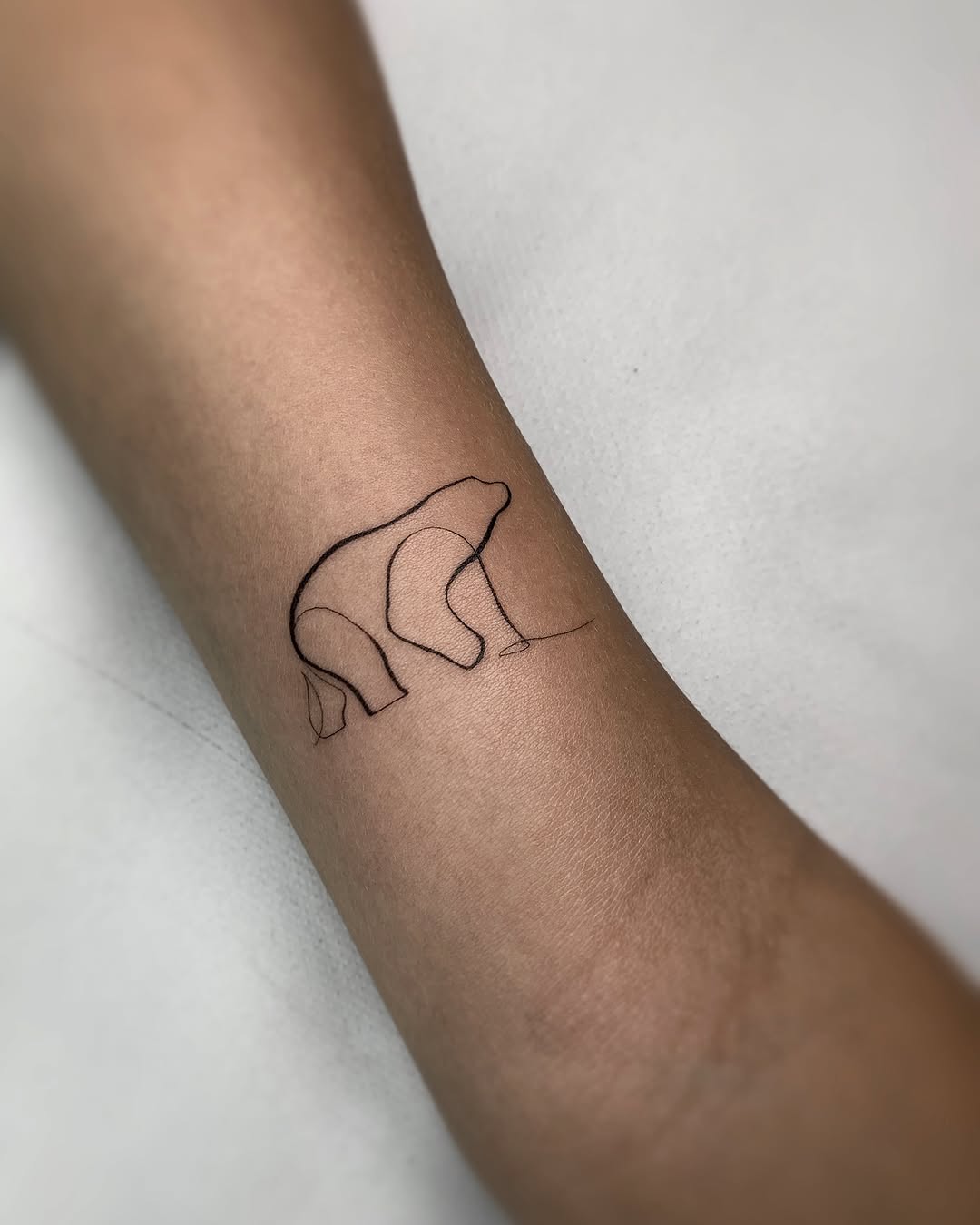 Elegant minimalistic bear tattoo design