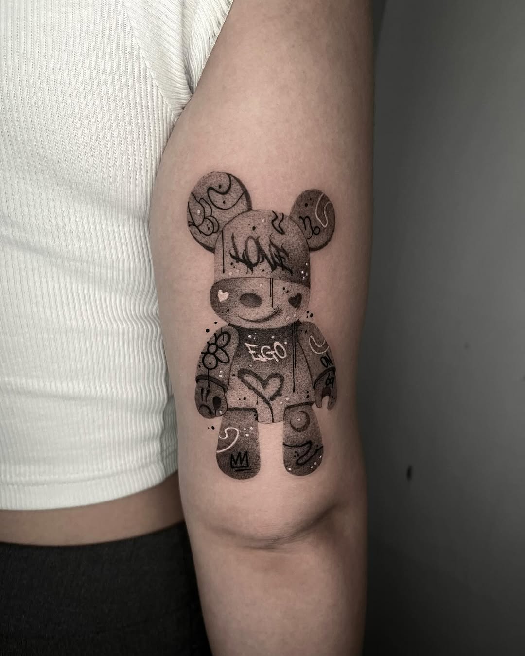 Playful bear tattoo with artistic flair